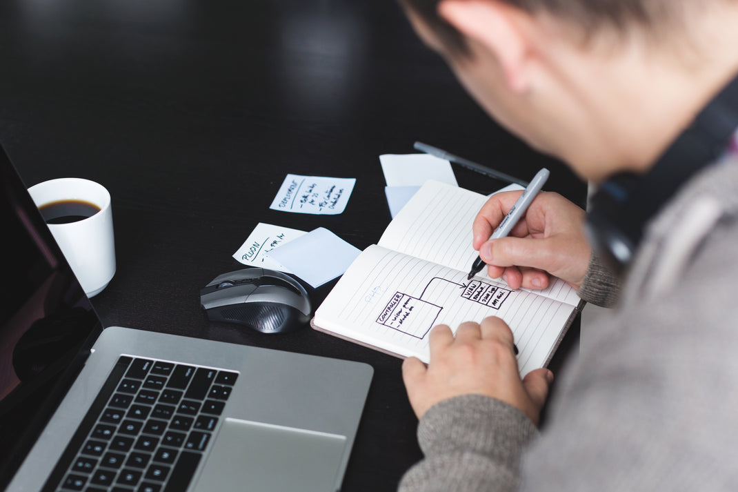 homme qui fait un plan dans un carnet ouvert